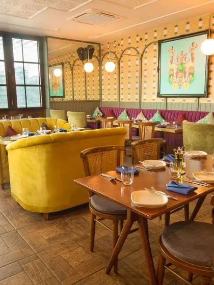 My Indiranagar dining room is set for another evening of stories and delicious food. The yellow velvet sofa is waiting for you.