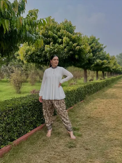 For a serene day outdoors, I paired a simple white peplum top with printed dhoti-style pants. It's a comfortable, breathable, and effortlessly chic Indo-western combination.