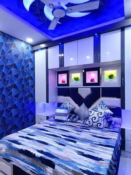 A bold choice for a bedroom, this geometric blue wallpaper is paired with a matching blue PVC ceiling light. The entire room is designed around a single color theme for a cohesive look.