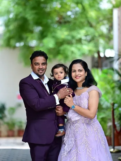 A beautiful family portrait. The mother is wearing my lavender rental gown, and I also offer coordinated outfits for men and children to complete the family look.