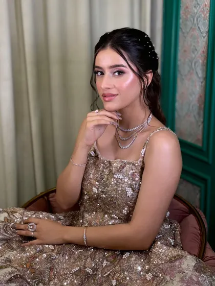 The final result of the soft glam demo, featuring shimmery eyes, glowing skin, and a beautiful gown.