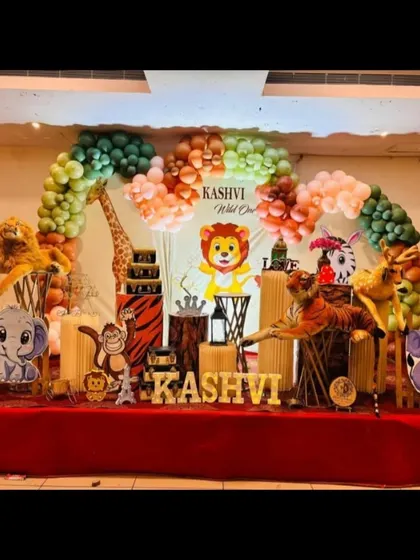 We can customize our jungle theme to fit your vision. This setup for Kashvi's "Wild One" party includes a mix of cartoon and plush animals, creating a playful and inviting atmosphere on stage.