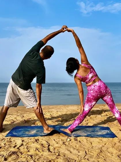 Trikonasana, or Triangle Pose, becomes a beautiful shared stretch in partner yoga. By holding hands, we can deepen the side-body stretch and find more stability in the pose together.