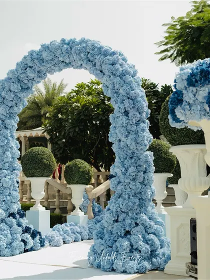 A detailed view of the magnificent floral arch. The sheer volume of blue hydrangeas used creates a powerful visual impact, demonstrating our ability to execute large-scale, monochromatic floral installations.