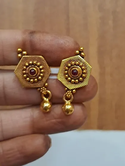 These hexagonal antique gold-plated earrings feature a small golden bead drop. They are lightweight and perfect for comfortable, all-day wear.
