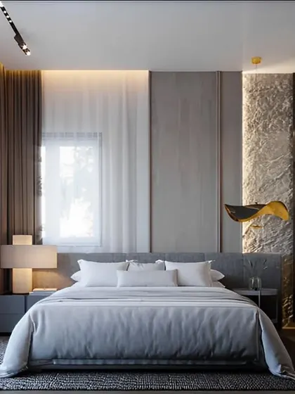 This bedroom showcases a modern design with a textured accent wall and a glass-paneled walk-in closet. The neutral color scheme and soft lighting create a serene and calming environment.