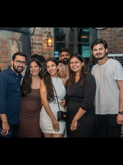 A group of friends posing for a picture, enjoying their night out.