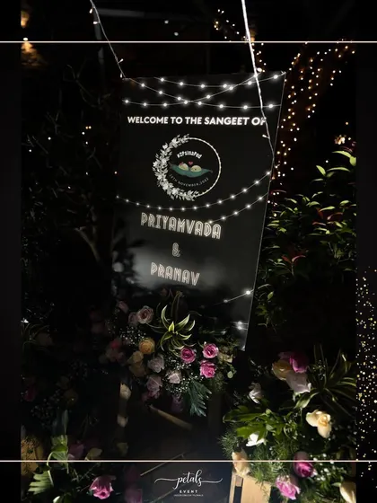 The welcome sign for the Sangeet night, adorned with flowers and fairy lights, sets the tone for a magical and musical evening.