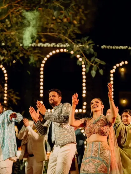 The entire wedding squad joining the couple on the dance floor for a group performance.