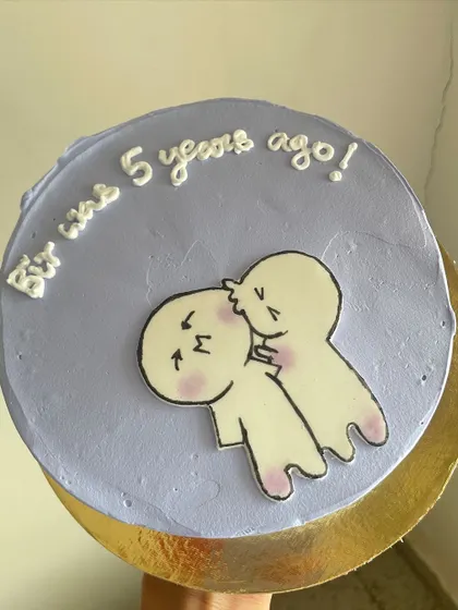 A cute and funny anniversary bento cake. The hand-drawn characters and message make it a really unique and memorable way to celebrate a milestone.