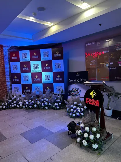 The stage and podium area for the restaurant launch event, with a branded backdrop.