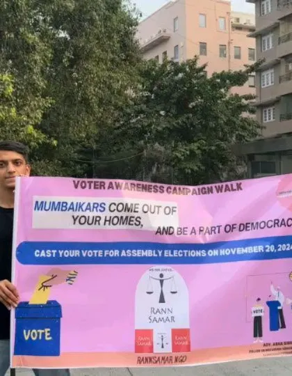 Two young students holding our campaign banner. Their involvement in spreading awareness is a testament to the power of youth in driving social change.