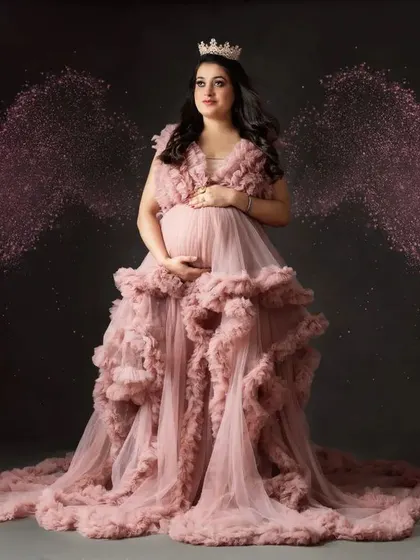 A magical, angelic portrait. We used editing to add sparkling pink wings to this mom-to-be in our pink cloud gown, creating a true fantasy image.