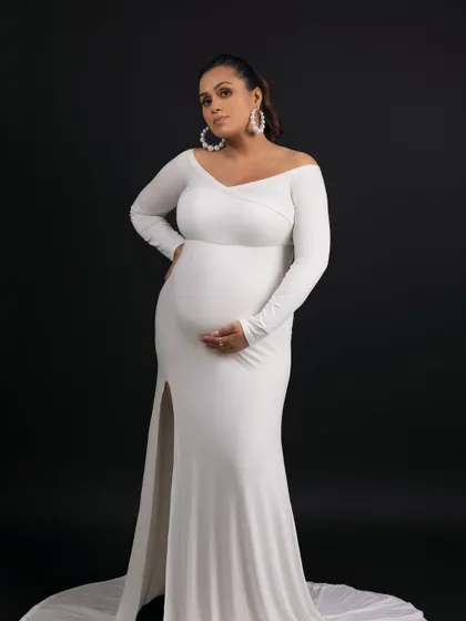This pose, with the thigh-high slit, is both elegant and modern, celebrating the beauty of the female form.