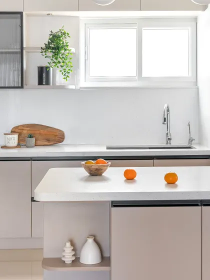 A closer look at the 'Beige and Beyond' kitchen island. The clean quartz countertop and integrated shelving provide a perfect spot for meal prep or a quick breakfast.