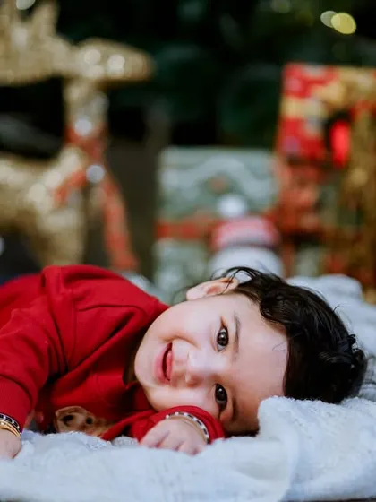 A sweet, candid moment from one of our Christmas mini sessions. We encourage kids to be themselves, which results in natural and heartwarming photos like this one.