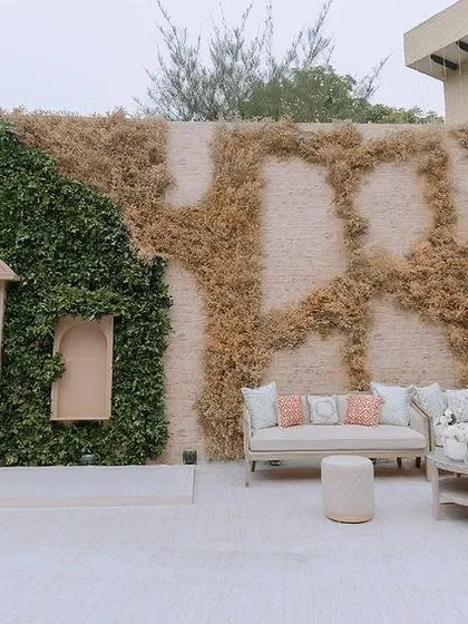 We designed this unique photo wall using a combination of preserved greenery and moss. The inset arch and seating area create a focal point that is both artistic and interactive.