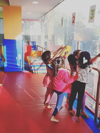 Our "Good Friends" class participating in the "Number Tumblers" theme. These images show the group learning advanced math and tumbling skills through warm-ups, stretches, and games.