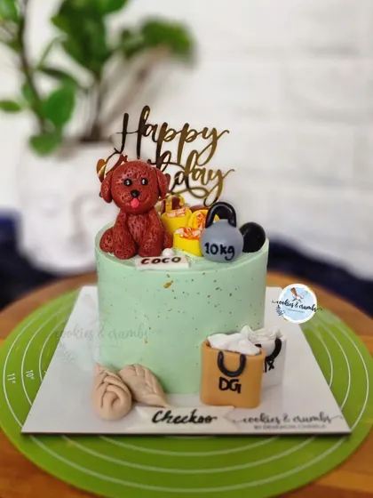 This cake is all about the birthday person's favorite things. It features a fondant dog, a kettlebell for the gym lover, shopping bags, and even little dumplings.
