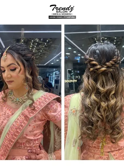 This shot showcases the beautiful hairstyle from the back. A braided crown with soft, flowing curls is a perfect choice for an engagement or reception, adding a touch of romance.