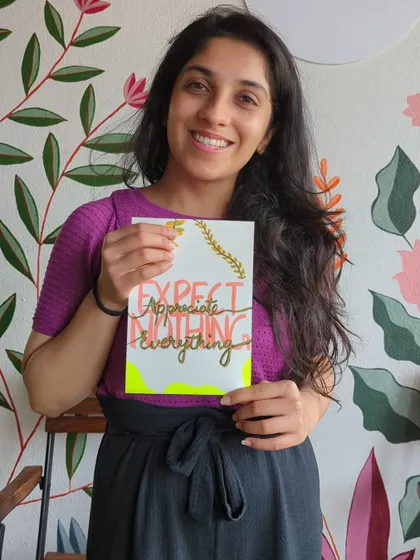 A participant with her inspiring "Expect Nothing, Appreciate Everything" calligraphy piece.