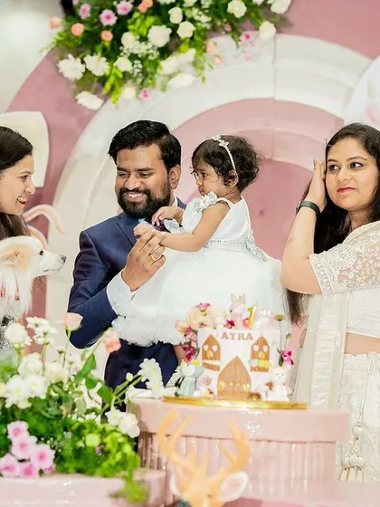 A candid moment during the cake cutting, with the family's beloved pet joining the celebration. We love creating events that include all family members.