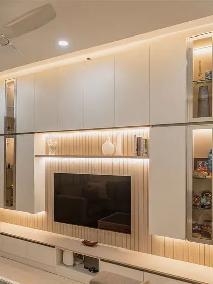 A detailed shot of the custom TV unit from the Vaswani Exquisite project, showing the clean lines and ample storage that define our minimalist approach.