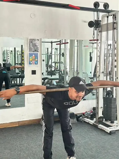 Good mornings with a stick to warm up the lower back and hamstrings.