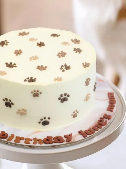 A close-up of the paw print cake, a simple and sweet design for any dog lover's celebration.