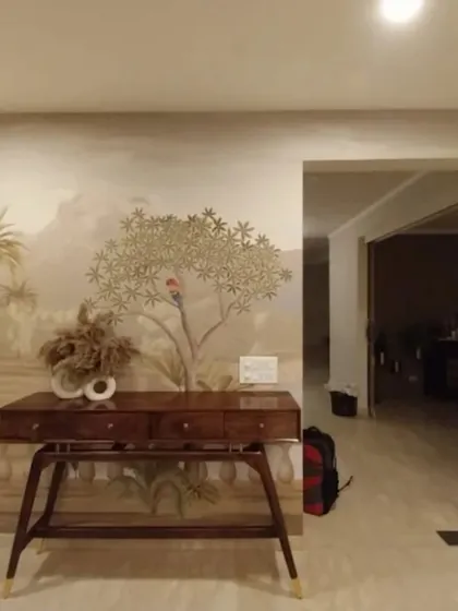 A panoramic landscape mural creates a sense of depth and artistry in this entryway, setting a sophisticated tone for the rest of the home.