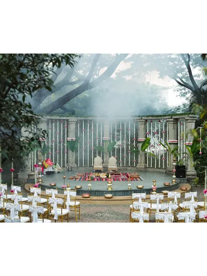 The stage is set for a beautiful union. This image captures the serene ambiance of the Shankaraa Foundation, with smoke from the sacred fire adding a mystical touch to the traditional decor.
