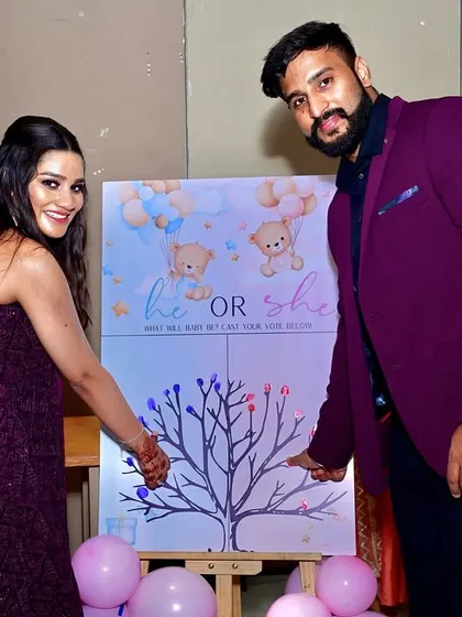 A unique gender reveal activity for the guests. The couple adds their fingerprints to a tree, casting their vote for 'he or she' on a custom-designed board.