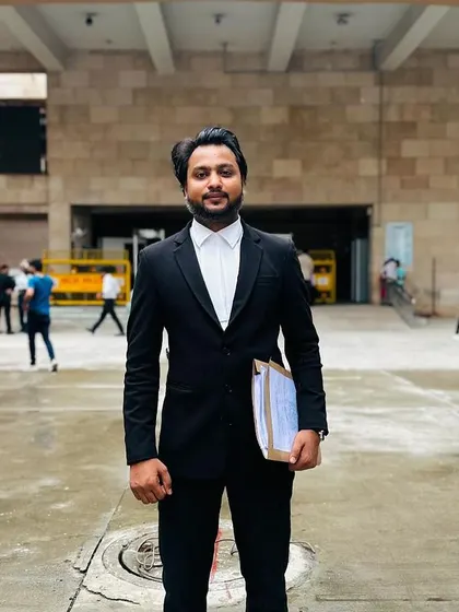 Standing outside Rohini Court with a case file in hand. I am always prepared and ready to argue for my clients.