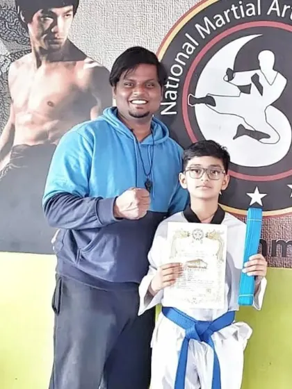 This student earns his blue belt, a significant achievement that reflects his advanced skills in Taekwondo.
