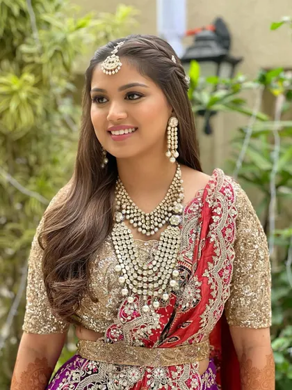 This portrait captures the intricate details of her jewelry and the soft, radiant makeup that complements it perfectly.