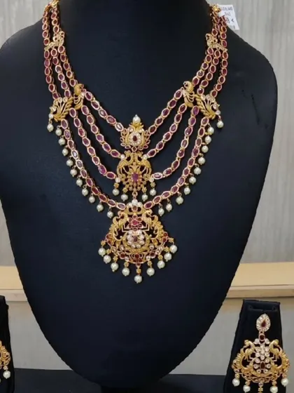 A four-layered haram with a temple-style pendant, studded with rubies and pearls. This piece adds depth and grandeur to a bridal look.