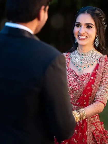 The look of love. A candid shot of the bride looking at her groom, her face lit up with happiness. Her reception makeup is soft, romantic, and simply perfect.