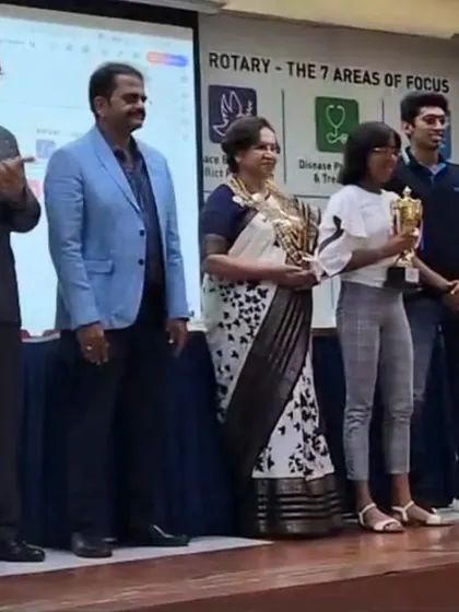 Our swimmer, Prachita Deb, receiving her Individual Championship trophy on stage at the award ceremony hosted by the Rotary Club.