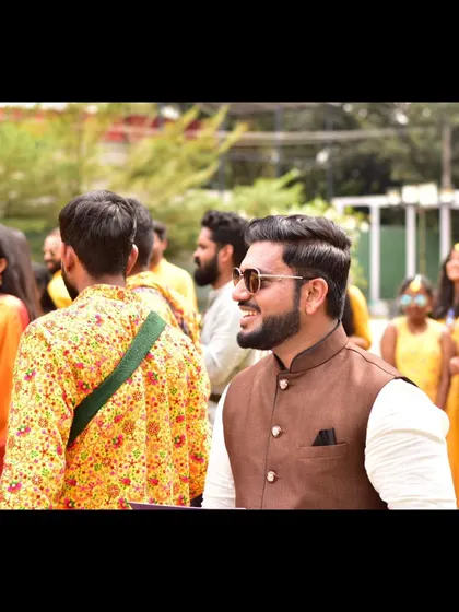 A happy, candid pose in the midst of the Haldi celebrations.