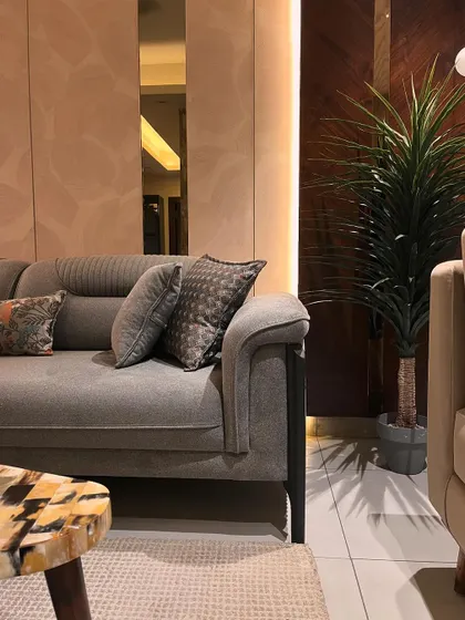 Details matter in creating a luxurious feel. Here, the texture of the sofa fabric, the pattern on the throw pillows, and the unique marble inlay of the side table all work together to create a rich, layered look.