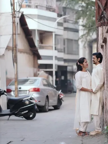 A quiet moment against a wall in a narrow lane. The depth of the street creates a beautiful leading line to the couple.