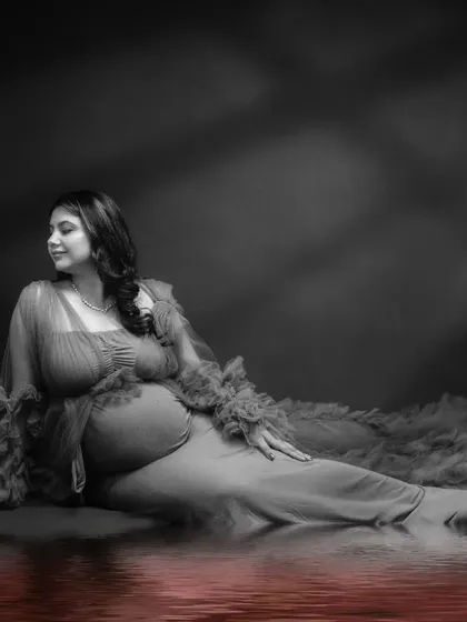 Reflecting on life's precious moments. This solo maternity photo is a masterpiece of creativity, with a color-pop reflection in the water.