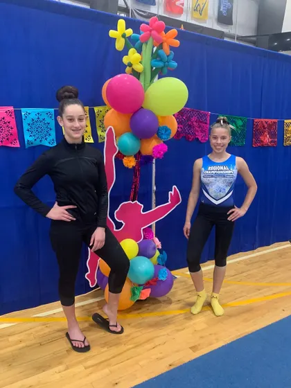 Posing with pride! Two of our Xcel athletes at their regional meet in San Antonio after an outstanding final competition.