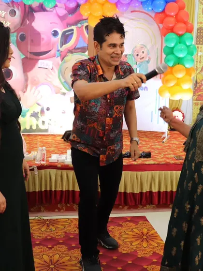 A fun, interactive moment with two guests during a game at a birthday party.