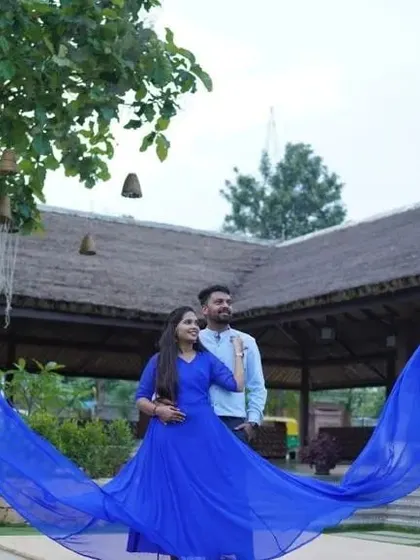 A dramatic outdoor shot of a couple with a blue 'flying trail' gown. Including your partner in these epic shots makes the memory even more special.
