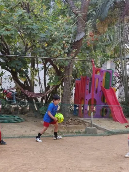 A young boy practices throwing the ball, a key skill in football that we teach through fun games.