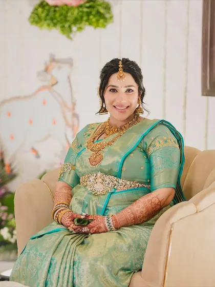 A happy mom-to-be. Her smile says it all. The makeup is designed to be light and comfortable, giving her a natural, radiant glow for her baby shower ceremony.