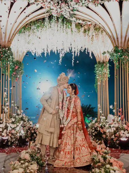A perfect moment under a sky of confetti and a canopy of flowers. We focus on capturing these grand, fairytale moments that feel like they are straight out of a movie, ensuring your wedding photos are as magical as the day itself.
