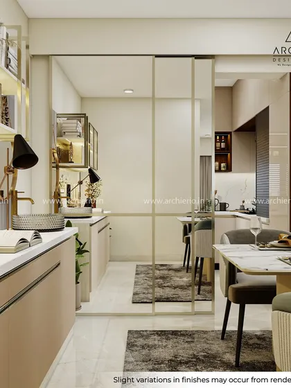A look from the crockery unit towards the dining area, showing how a glass partition can define spaces without closing them off. This maintains an open, airy feel while creating distinct zones.