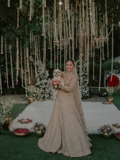 A heartwarming portrait of the bride holding her pet dog, a special member of the family.